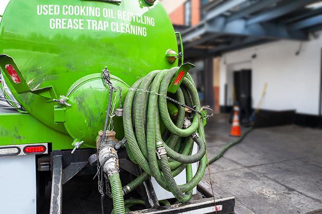 a vacuum truck pumping out a large underground grease trap in Alviso